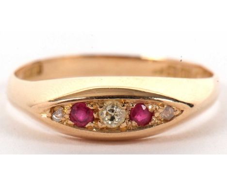 An 18ct ruby and diamond ring, the marquise shape plaque set with alternating rubies and diamonds, with tapered shoulders and