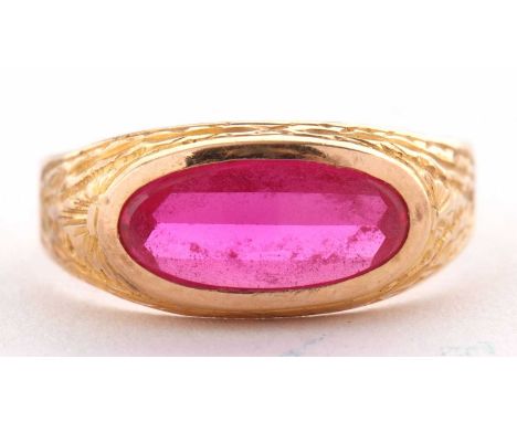 A continental synthetic ruby ring, the oval mixed cut synthetic ruby collet mounted with engraved decoration to surround and 