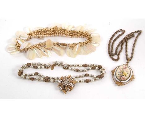 Three necklaces by Miriam Haskell, the first with a white paste and gilt metal flowerhead cluster set with gilt leaves and fu