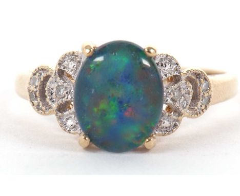 A 9k opal triplet and diamond ring, the oval opal triplet, claw mounted with diamond set shoulders tapering to a plain band s