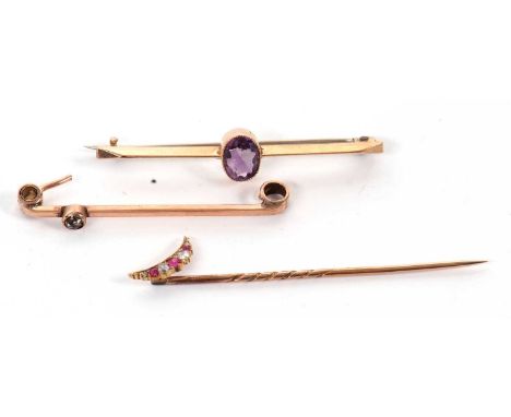 A ruby and rose cut diamond crescent moon stick pin, unmarked, together with a 9ct amethyst bar brooch and a 9ct white stone,