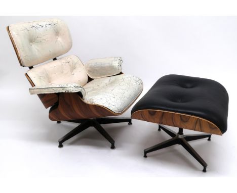 A CHARLES & RAY EAMES FOR HERMAN MILLER MODEL 670 LOUNGE CHAIR AND 671 OTTOMAN STOOL both with black leather upholstery on la