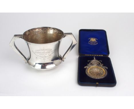 CURLING INTEREST; A silver and gilt presentation curling medal, by David McGregor &amp; Co, Edinburgh 1899, cast with two cro