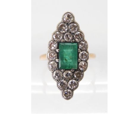 AN EMERALD AND DIAMOND RING mounted in yellow and white metal, the step cut emerald with the dimensions of 7mm x 5mm x 4.6mm,