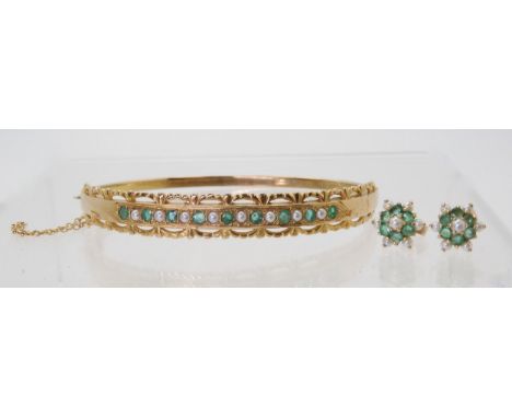 AN EMERALD &amp; PEARL BANGLE AND EARRINGS the 9ct bangle is set with alternate emeralds and pearls with a decorative pierced