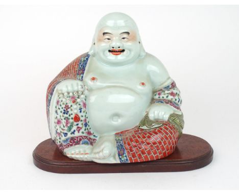  A CHINESE MODEL OF BUDDHA&nbsp; seated with rosary beads and patterned costume, on a wooden stand, impressed mark to base, 2