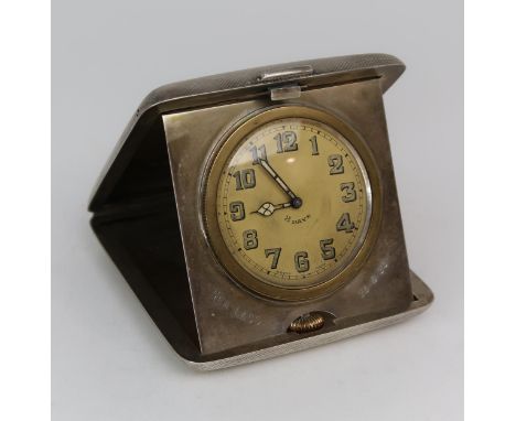 A GEORGE V SILVER MOUNTED TRAVELLING CLOCK the case by&nbsp;William Base &amp; Sons, Birmingham 1928, of canted square form, 