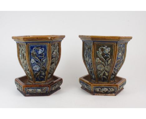 A PAIR OF UNMARKED DOULTON STONEWARE JARDINIERES AND SAUCERS each of hexagonal form with panels of flowers, one marked with i