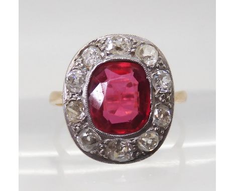 A VINTAGE RED GEM &amp; DIAMOND RING the ring is mounted in yellow and white metal and set with a synthetic ruby with the dim