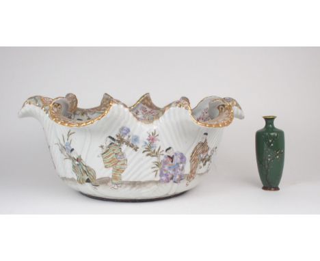 A LARGE KUTANI BASIN  The everted wavy rim above a frieze of figures at various pastimes ,20cm high, 46cm wide and with a Jap