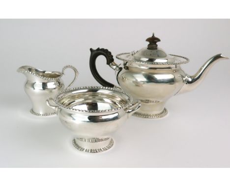 AN EDWARDIAN BACHELORS SILVER TEA SERVICE maker's mark rubbed, London 1911, of baluster form, with a spreading foot and beade