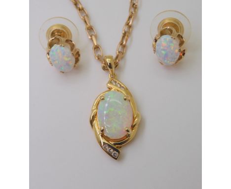 AN 18CT GOLD OPAL &amp; DIAMOND PENDANT set with a 14mm x 9.8mm solid white opal, and diamond accents with an estimated appro