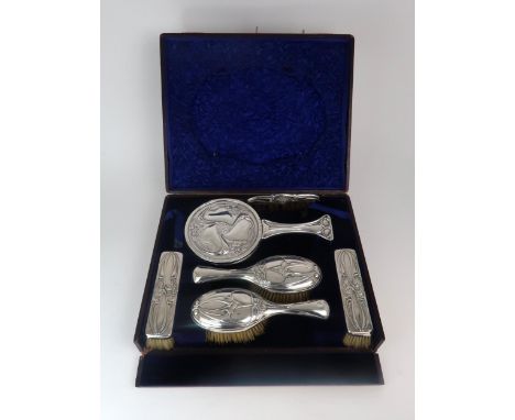 KATE HARRIS FOR WILLIAM HUTTON &amp; SONS; a cased six piece Art Nouveau silver dressing table set, comprising a circular han