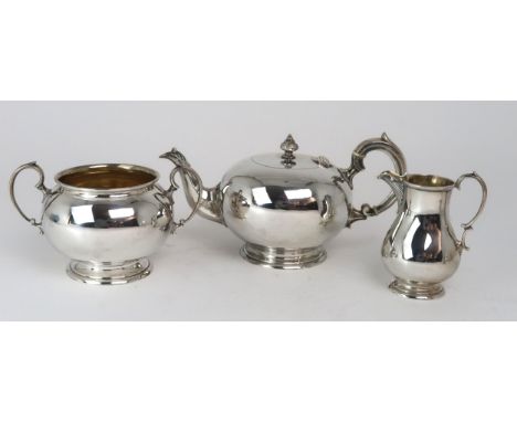 AN EDWARDIAN SILVER BACHELORS TEA SERVICE by Martin, Hall &amp; Co, Sheffield 1902, of globular form, with a cast acanthus fi