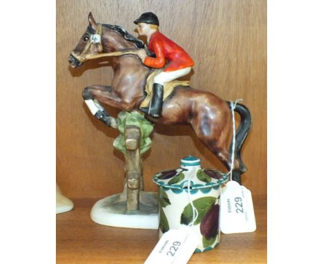 A Wemyss preserve pot decorated with plums, 7cm high and a Goebel figure of a rider and hose jumping a fence, 20cm high, (2).