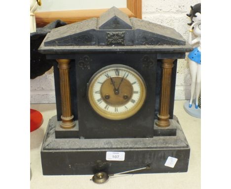 A black slate striking mantel clock of architectural form, the movement stamped Marti, (bell lacking), 33cm high.