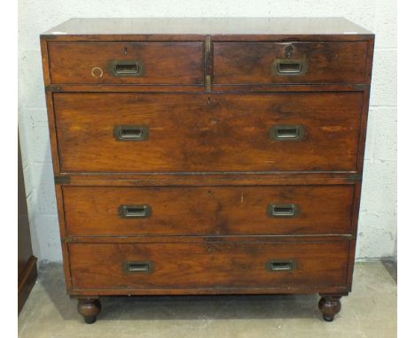 A Victorian teak two-part military chest by Army & Navy CSL, comprising two short and three long drawers, on original turned 