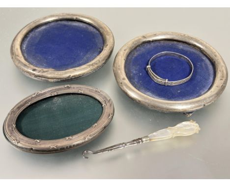 A pair of Birmingham silver circular photo frames with easel stands missing glass, a Birmingham Edwardian silver oval photo f