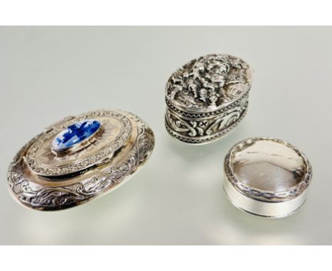 A Edinburgh silver circular pill box with pull up top and celtic plat border D x 3cm, a modern Dutch white metal oval shaped 