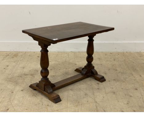 An early 20th century oak stretcher table, the oval top raised on panel end supports. H58cm, W71cm, D46cm.&nbsp;