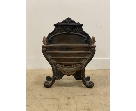 A 20th century cast iron fire grate, with cast brass acorn finals and out swept supports. H62cm, W47cm, D28cm.&nbsp;