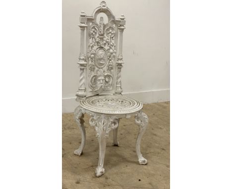 A Coalbrookdale style heavy cast iron garden chair, first half of the 20th century, the back decorated with mask and floral m