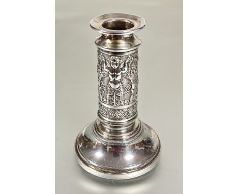 A continental white metal column single candle stick with chased central panel with alternating cherub and basket of flower d