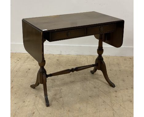 A reproduction mahogany sofa table, with drop leaf to each end, above two frieze drawers, raised on turned end columns and fo