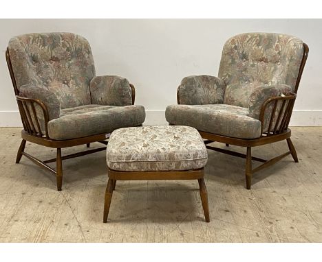 Ercol, a pair of Vintage stained beech framed lounge chairs, with hoop and spindle back above squab cushions, raised on turne