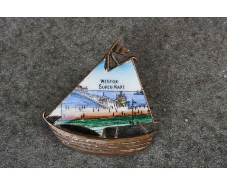 A early 20th century enamel souvenir brooch from Weston Super Mare in the form of a ship. 
