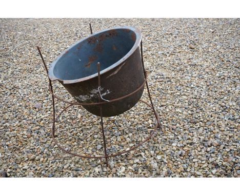 A cast iron garden planter, measures approx 52cm across the rim. 