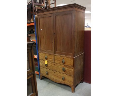 Early 19th century Mahogany Linen Press, converted to a wardrobe, the two panel doors opening to a hanging space with rail, a