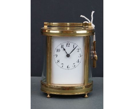 An antique brass cased carriage clock with white enamel dial, complete with key. 