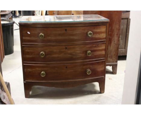 Early 19th century Mahogany Bow Fronted Chest of Three Long Drawers raised on swept bracket feet, with glass cover, 92cms wid