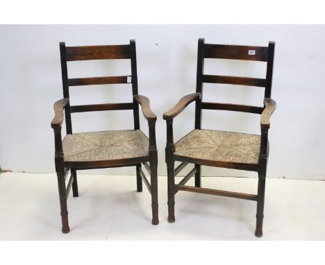 Pair of Oak Ladder Back Elbow Chairs with Rush Seats, 58cms wide x 102cms high 