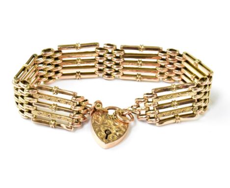 A late 19th/early 20th century rose gold five bar gate bracelet, united with a 9ct heart-shaped padlock clasp, with floral cu
