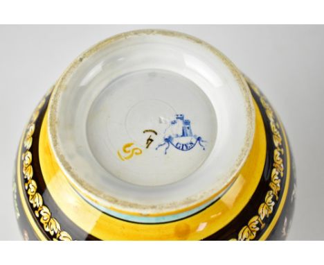GIEN; a faience ware brown glazed earthenware jug decorated with mythical figures within geometric bands of floral decoration