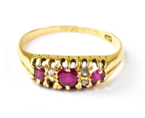 An 18ct gold ruby ring in the Victorian style, with central ruby flanked by two rows of two tiny rough cut diamonds (one miss