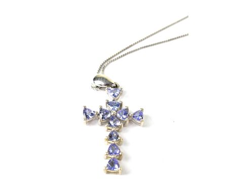 A silver tanzanite set cross on a silver link chain and a silver ring set with five blue tanzanites, size R (2).