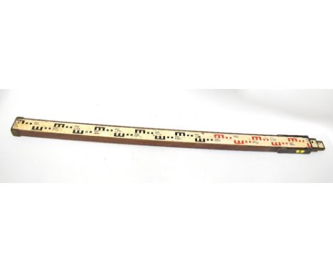 A vintage wood and brass three-section surveyor's staff/rod.