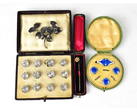 A cased set of twelve Edwardian diamanté buttons, an Edwardian 9ct gold stick pin with small diamond, a silver and enamelled 