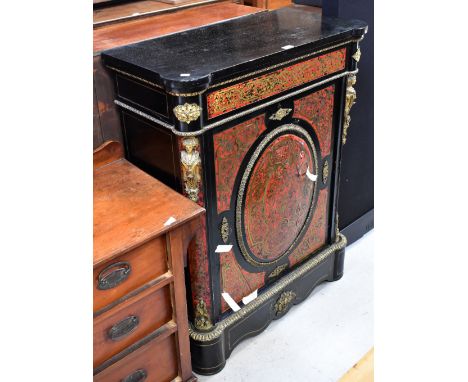 A 19th century ebonised gilt brass mounted boulle work side cabinet, with single door centred with an oval boulle work panel,