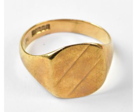 A gentlemen's vintage 9ct gold signet ring, with square table, horizontal blank panel flanked by line decoration either side,