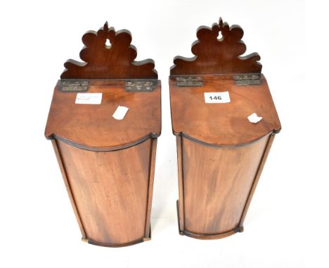 A pair of 19th century walnut wall mounted candle boxes, the shaped backs above sloping hinged lids, bow-fronted body to flat