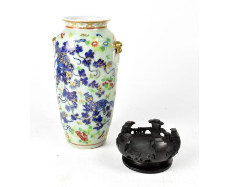 A late 19th century Chinese celadon baluster vase with enamel bird, butterfly and floral decoration in the Famille Rose palet