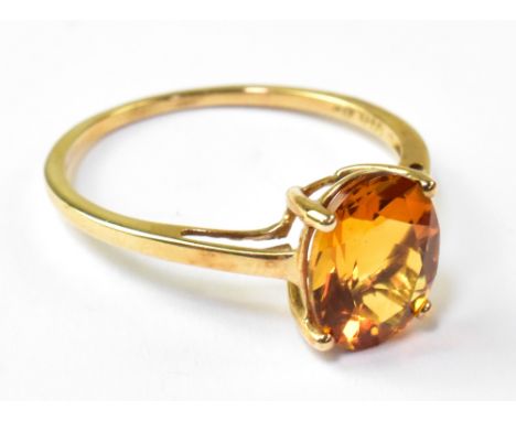 A 9ct yellow gold ladies' dress ring with oval facet cut orange stone, size R, approx 1.1g.