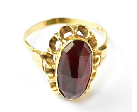 A vintage 14ct gold dress ring with marquise-shaped cut garnet, in a frilled 14ct gold mount, size R, approx 3.2g.