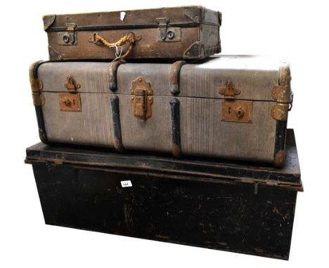 Two early 20th century travel trunks comprising a black metal example and a card example with metal struts, the largest 33 x 
