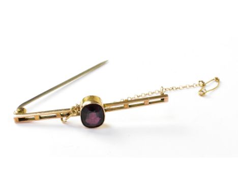 A 9ct gold ladder-style bar brooch with central cut amethyst in bezel set mount, steel pin and gold safety chain and pin, in 