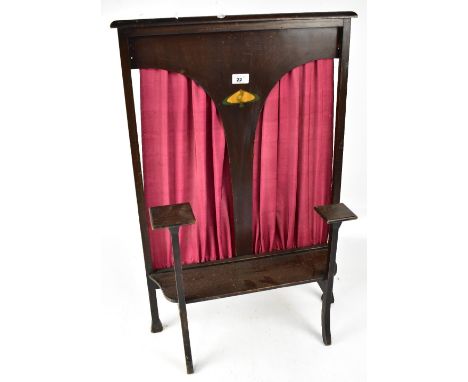 An early 20th century Arts &amp; Crafts fire screen with Art Nouveau inlay to centre panel, red silk curtains to back, 78 x 5